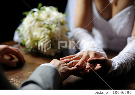 Bride and groom holding their hands Bride and groom holding their hands 10046599
