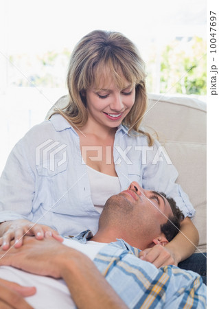 Man resting on happy womans lap on couch 10047697