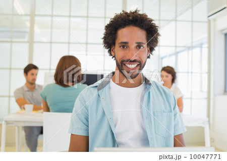 Portrait of a smiling businessman with colleagues in meeting Portrait of a smiling businessman with colleagues in meeting 10047771