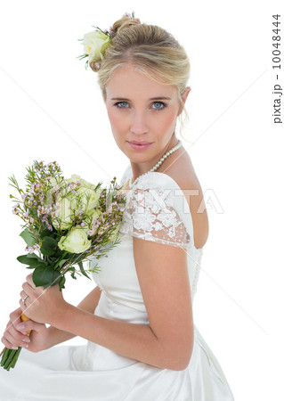 Bride holding rose bouquet over white background Bride holding rose bouquet over white background 10048444