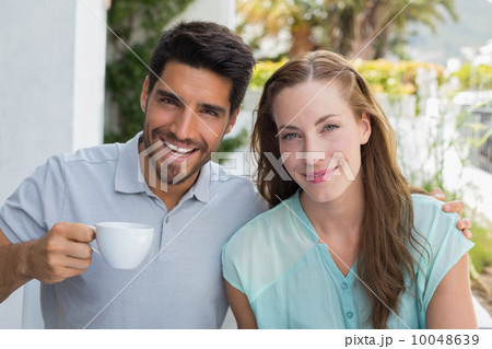 Smiling couple with coffee cup at cafÃ© 10048639