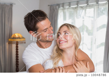Loving man embracing woman from behind 10048786