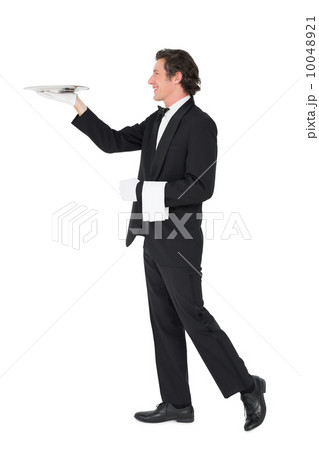 Waiter carrying tray over white background Waiter carrying tray over white background 10048921