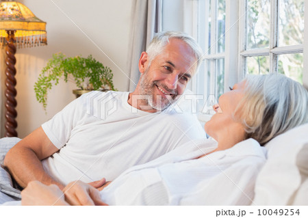 Happy mature couple relaxing in bed 10049254