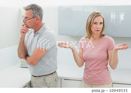 Unhappy couple having an argument in kitchen 10049535