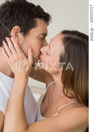 Loving young couple kissing at home Loving young couple kissing at home 10050557