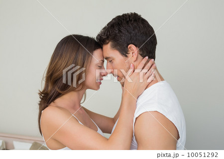 Side view of a loving couple with eyes closed 10051292