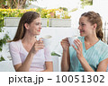 Female friends having coffee at coffee shop 10051302