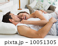 Cheerful young couple lying together in bed 10051305