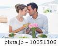 Loving couple toasting wine glasses at lunch table 10051306