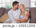 Relaxed loving couple sitting on sofa 10051309