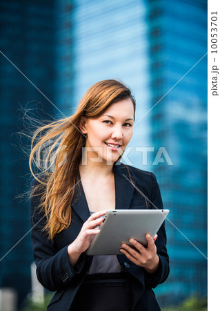 Young female pan-asian executive using a tablet 10053701