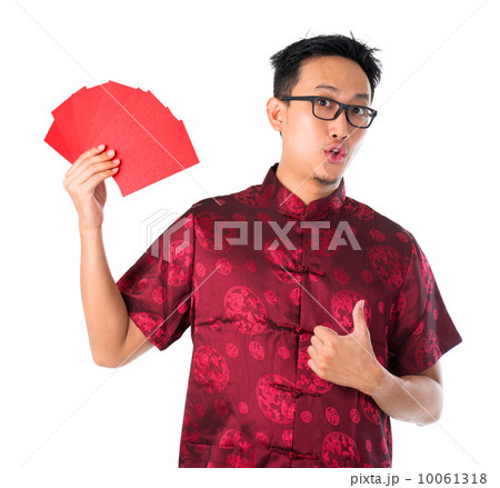 Shocked Asian Chinese man holding many red packets Shocked Asian Chinese man holding many red packets 10061318