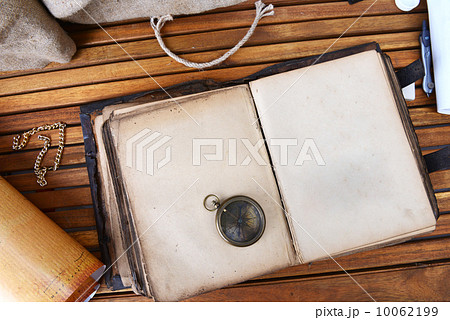 compass and watch on old book compass and watch on old book 10062199