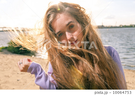 Long haired blonde outdoors wind 10064753