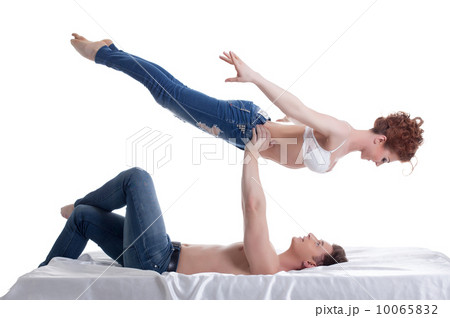 Image of attractive young gymnasts posing in bed 10065832