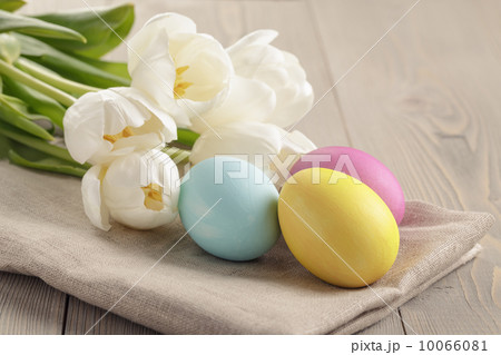 pastel color easter eggs with tulips on table 10066081