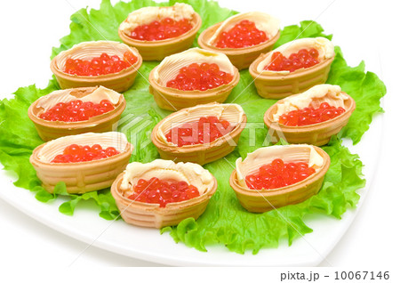 Tartlets with red caviar on a plate on white background 10067146