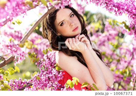 Pretty girl in spring park with pink flowers Pretty girl in spring park with pink flowers 10067371