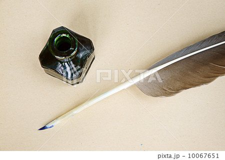 Feather, ink and sheet of old paper 10067651