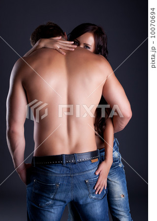 Shy girl looking over her lover's shoulder Shy girl looking over her lover's shoulder 10070694