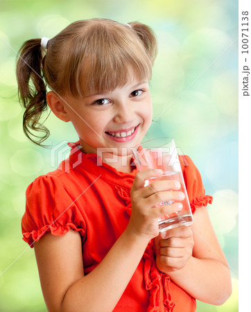 Schoolgirl portrait with water glass outdoor 10071138