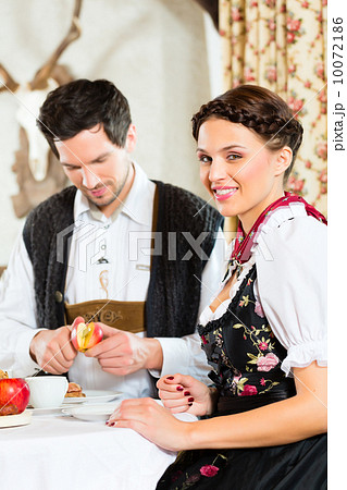Young couple in a hunter's cabin eating 10072186