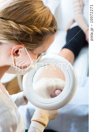 Woman in poidatry studio receiving pedicure Woman in poidatry studio receiving pedicure 10072271
