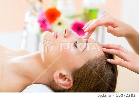 Wellness - woman getting head massage in Spa 10072283