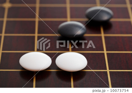 few stones during go game playing on goban 10073754
