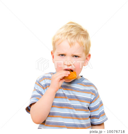 Cute little boy eating delicious cookie isolated on white 10076718