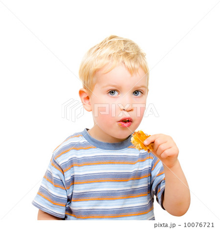 Cute little boy eating delicious cookie isolated on white 10076721