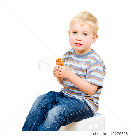 Cute little boy eating delicious cookie isolated on white 10076723