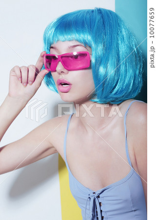 Individuality. Woman wears Blue Glossy Wig and Pink Glasses 10077659