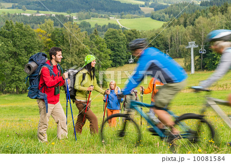Tourists hiking and riding mountain bikes summer nature 10081584