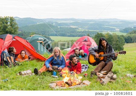 Camping students listening girl with guitar tents Camping students listening girl with guitar tents 10081601