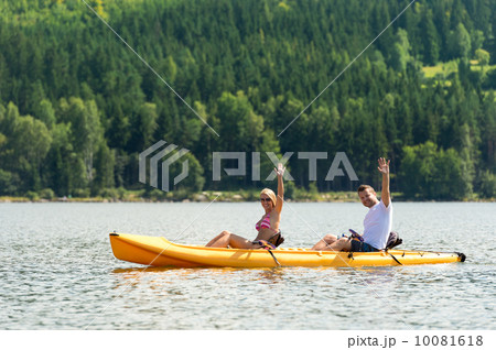 Man and woman kayaking on pond vacation Man and woman kayaking on pond vacation 10081618