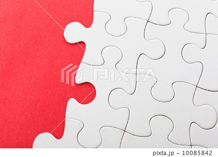 Unfinished puzzle over red background 10085842