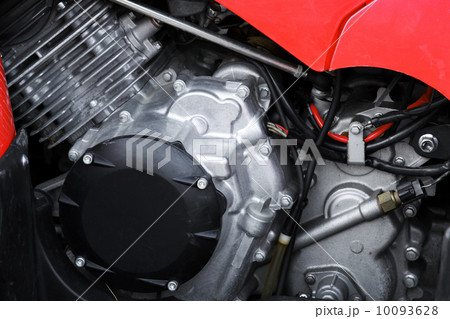 Sport motorcycle engine under red cover, closeup photo 10093628