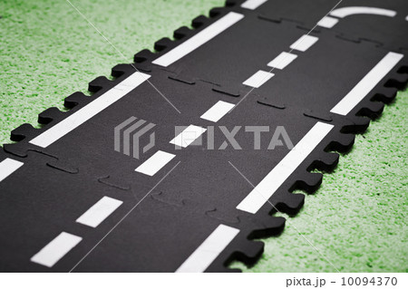 Abstract road background with playground carpet and toy road tiles Abstract road background with playground carpet and toy road tiles 10094370