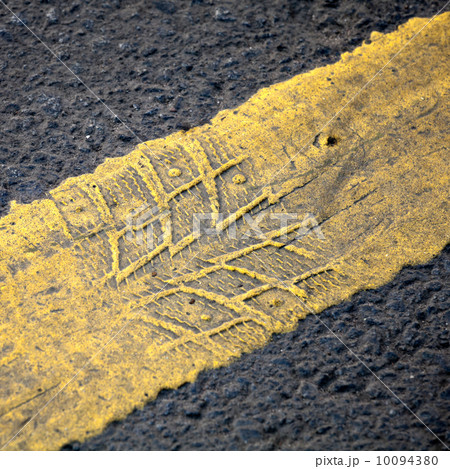 Abstract road background with yellow line and tire imprint on th Abstract road background with yellow line and tire imprint on th 10094380