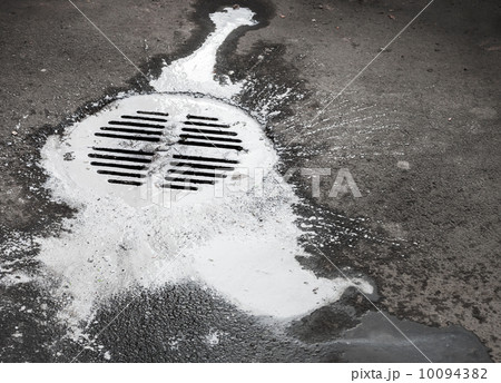 White paint flows into the manhole. Pollution metaphor White paint flows into the manhole. Pollution metaphor 10094382