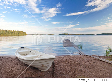 Coastal landscape with old white boat on the coast of Saimaa lake, Finland Coastal landscape with old white boat on the coast of Saimaa lake, Finland 10094449