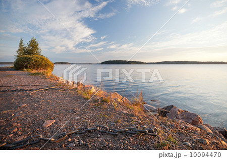 Black ships chain on the coast of Saimaa lake, Finland 10094470
