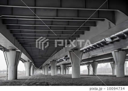 Dark urban scene under modern automotive bridge Dark urban scene under modern automotive bridge 10094734