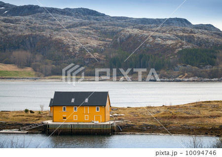 Norwegian village with yellow wooden house on Sea coast 10094746