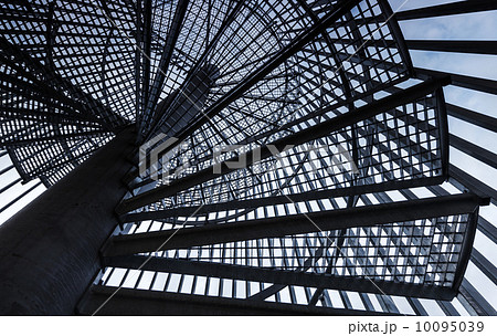 Metal modern spiral staircase details with blue sky one background 10095039