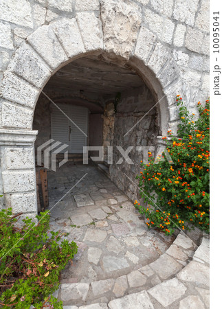 Stone arch, entrance to ancient house in Perast town, Montenegro 10095041