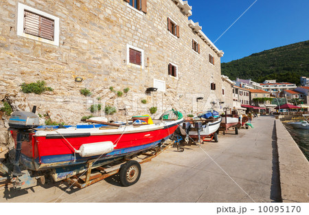 Red fishing boat stands on the coast Red fishing boat stands on the coast 10095170