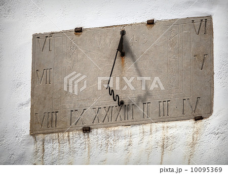 Ancient sundial with signs of the zodiac on white church wall in Tallinn, Estonia 10095369